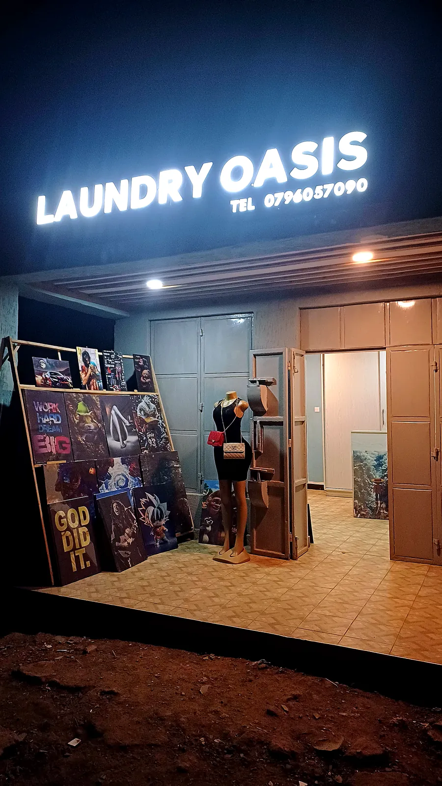 Laundry Oasis storefront at night, lit signage above the entrance