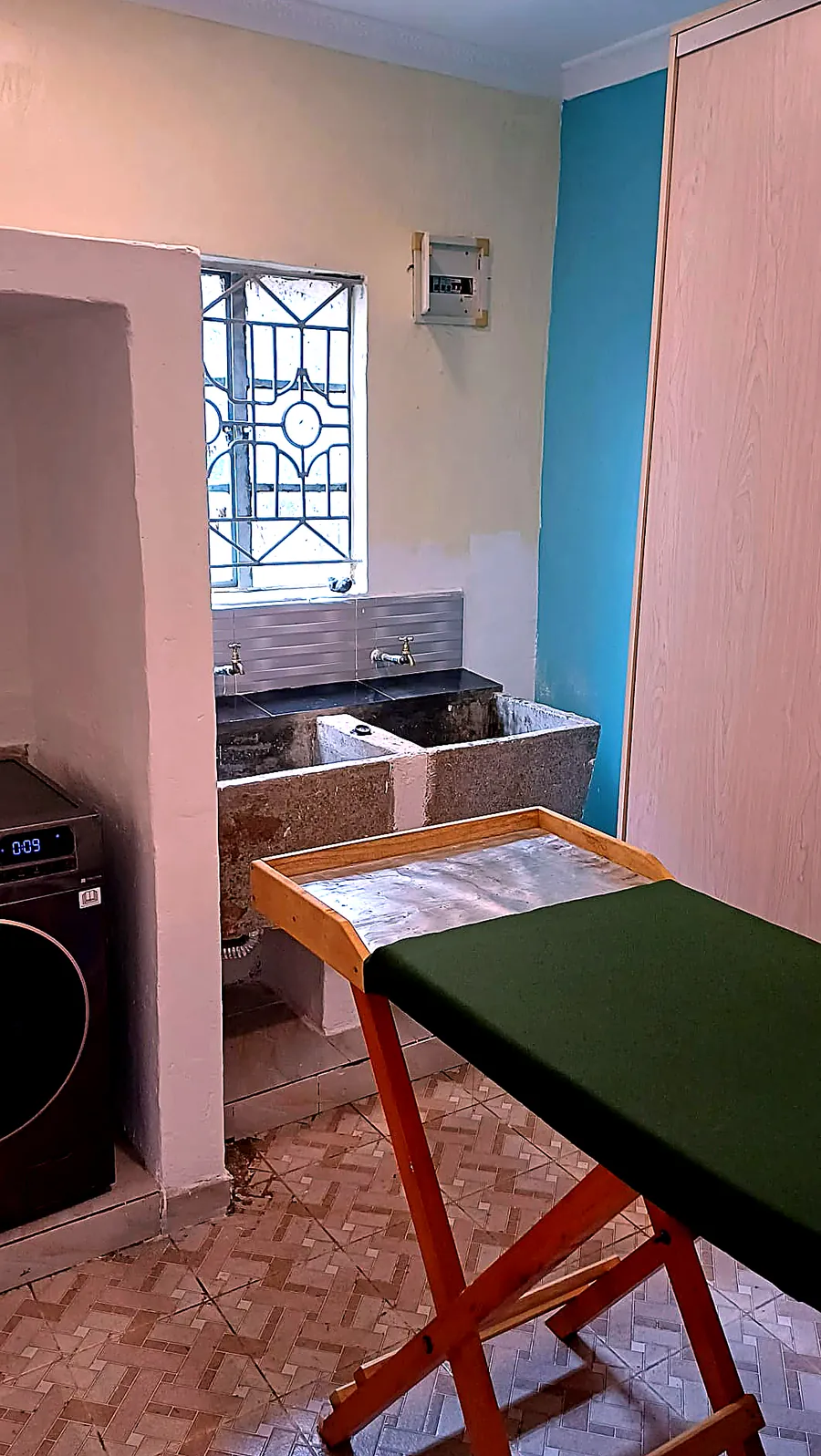 Dedicated ironing and pressing station beside the wash sinks